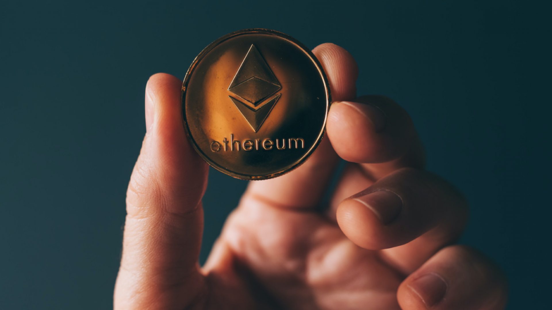 Ethereum cryptocurrency in hand, blockchain technology decentralized currency coin